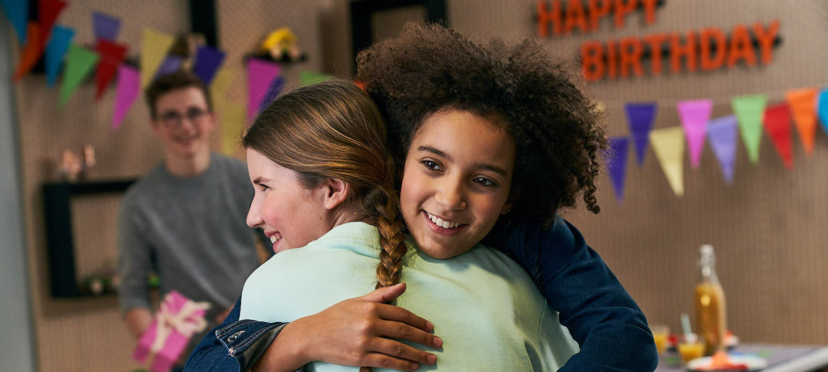 Children hug each other at a birthday party at BMW Welt